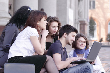 Fototapeta premium group of fellow students with books and laptop
