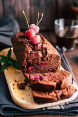 Chocolate cake with cherries on a dark wooden background, dessert, baked goods