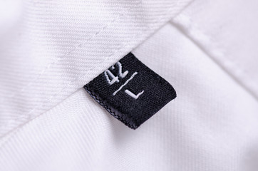 White shirt macro tag size L texture background