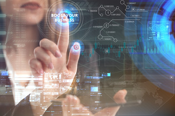 The concept of business, technology, the Internet and the network. A young entrepreneur working on a virtual screen of the future and sees the inscription: Boost your business