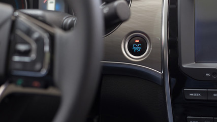 Obraz na płótnie Canvas Start, stop engine button. Modern car interior. Luxurious car instrument cluster. Close up shot of car instrument panel.