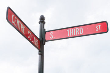 Blank directional road signs against blue sky. 
