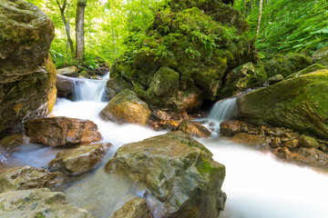 Obraz premium Mountain stream with falls