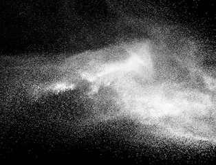 Bizarre forms of of white powder explode on cloud against colorful background.  Holi powder festival.