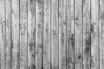 Naklejka premium Old fence from wooden boards,wooden background, black and white texture