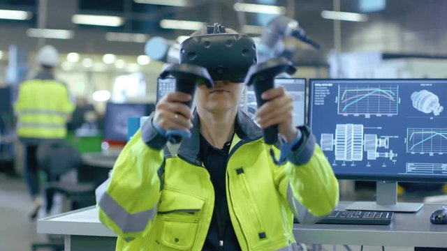 Portrait Female Mechanical Engineer Wearing Virtual Reality Headset and Making Gestures with Controllers, She Uses VR technology for Industrial Design, Development and Prototyping in CAD Software. 