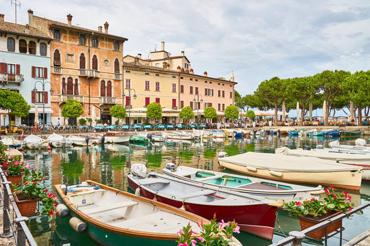 Harbor with colorful boats in the city of "Desenzano del Garda" at Lake Garda in northern Italy