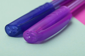 closeup of colorful ballpoint pens on color background