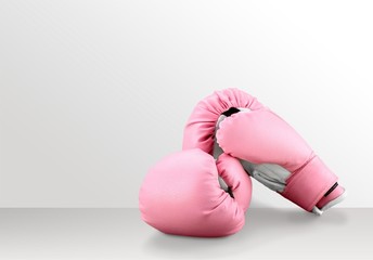 Pink boxing gloves on desk