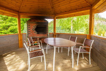 Veranda with brick brazier. Place for cooking barbecue. Outdoor fireplace. Alcove. Cooked food on the coals.