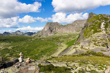 Cairn against trail mountains. Natural park Ergaki, Western Sayan mountains, Siberia, Russia