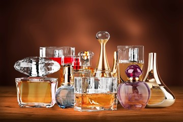 Aromatic Perfume bottles on white wooden desk
