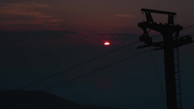 Time lapse of a clouds rolling over a green mountain slopes