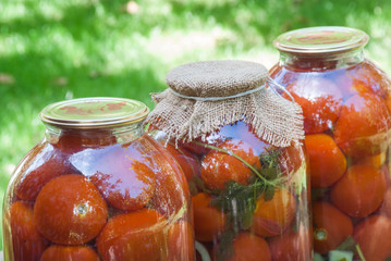 Canning tomatoes in glass jars with spices