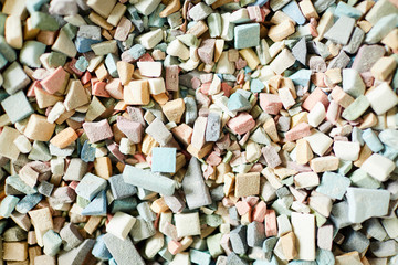 Overview of pile of colorful ceramic workpieces needed to be processed before creating mosaic masterpiece