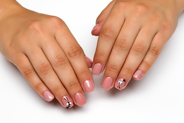 beige pink manicure with sequins and an ant on square short nails
