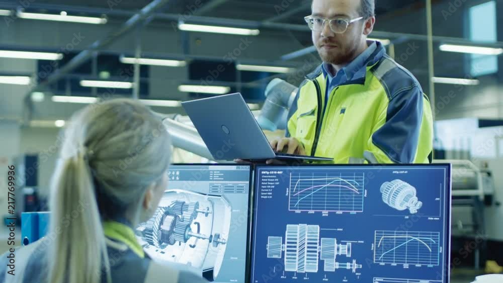 Poster At the Factory: Male and Female Mechanical Engineers Use Laptop and Personal Computer while Talking. Screen Shows 3D Engine Concept made with CAD Software.