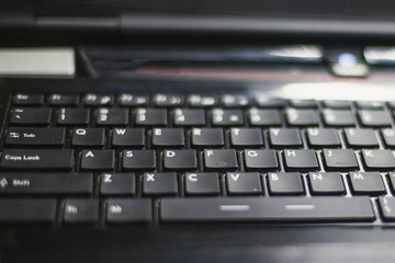 computer keyboard buttons on laptop, blurry, close up