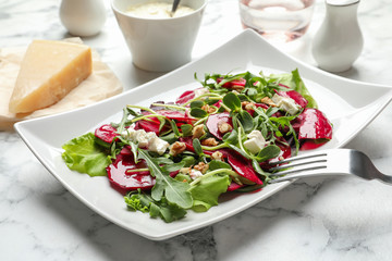 Plate with delicious beet salad served on table