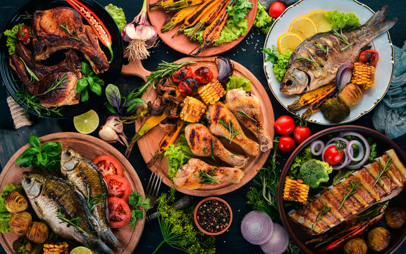 A set of food. Steak, Fish, Vegetables and Spices. On a wooden background. Top view. Copy space.