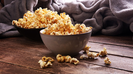 Salt popcorn or sweet popcorn in bowl on the wooden table