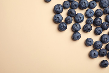 Flat lay composition with tasty blueberry and space for text on color background