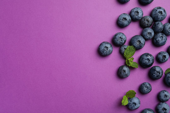 Fototapeta Flat lay composition with tasty blueberry and space for text on color background
