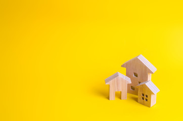Three houses on a yellow background. Buying and selling of real estate, construction. Apartments and apartments. City, settlement. Minimalism. for presentations. real estate market.