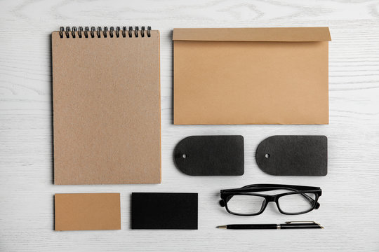 Flat lay composition with stationery on white wooden background. Mock up for design