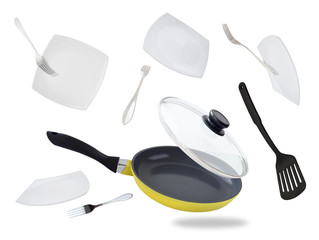 Set of flying and falling frying pan, flat plates and forks isolated on white background. Kitchen...