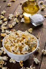 Air salty popcorn.A bowl of popcorn on a wooden table.Salt popcorn on the wooden background .  With space for text.Top view.popcorn texture.Chees .