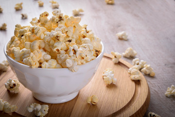 Salt popcorn on the wooden table, selective focus