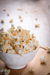 Salt popcorn on the wooden table, selective focus