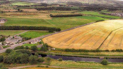 Fototapeta premium Aerial image over the main road into Kirkintilloch and the Forth and Clyde Canal.