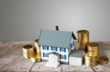 Model of house with coins on table