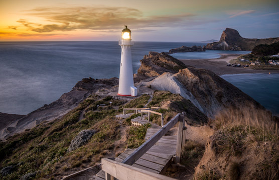Castlepoint Lighthouse New Zealand light on at sunrise