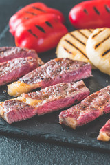 Grilled beef steak with bell peppers and cheese