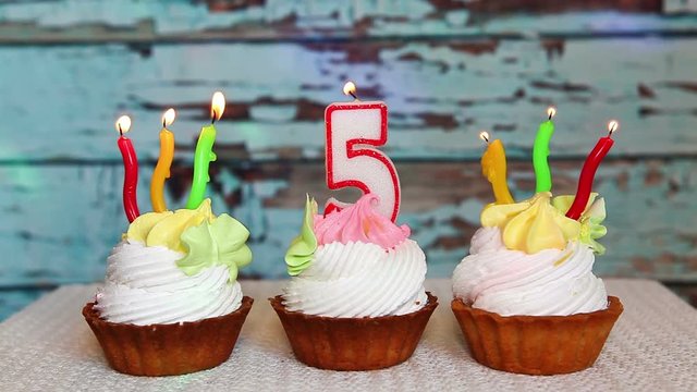 Happy fifth birthday with number five candle on cake, colorful anniversary concept