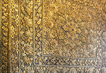 Wat Pho temple wall detail with intricate flower patterns. Bangkok, Thailand.