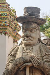 Fototapeta na wymiar Chinese warrior statue at Wat Po, or Temple of the Reclining Buddha. Bangkok, Thailand.