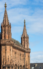 Edinburgh, Scotland, UK - June 13, 2012: Spires and short facade in brown stone of Scottish...