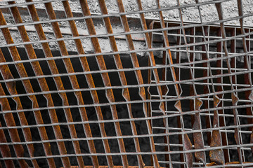 Rusty broken metal grille is close