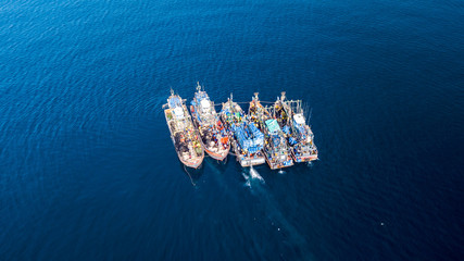 Aerial drone view of fishing trawlers in the ocean in asia