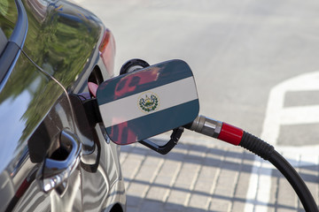 Fueling car with petrol pump at a gas station.