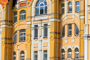 Fototapeta na wymiar Facade of the modern multistory building in classical style close-up