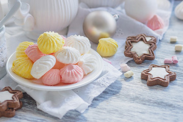 Cup of cacao with marshmallow, cookies, meringues and different Christmas decorations