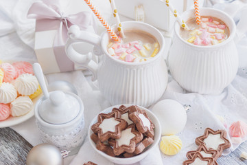 Cup of cacao with marshmallow, cookies, meringues and different Christmas decorations