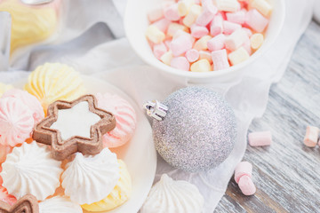 Fototapeta na wymiar Marshmallow, cookies, meringues and different Christmas decorations