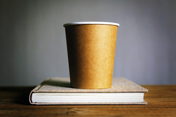 paper glass with coffee on the book
