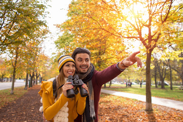 Happy young couple exploring in autumn at the park